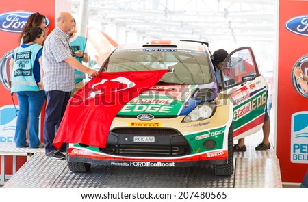 ISTANBUL, TURKEY - JULY 12, 2014: Murat Bostanci with Ford Fiesta S2000 of Castrol Ford Team Turkey in start podium of 35. Istanbul Rally
