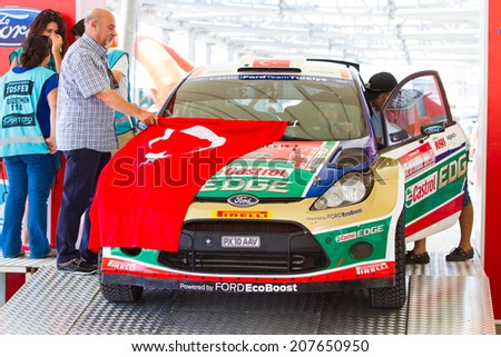 ISTANBUL, TURKEY - JULY 12, 2014: Murat Bostanci with Ford Fiesta S2000 of Castrol Ford Team Turkey in start podium of 35. Istanbul Rally