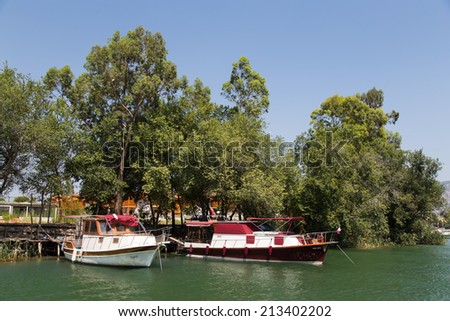 DALYAN, MUGLA, TURKEY - JULY 18, 2014: Tour boats in Dalyan river. River tour between Koycegiz lake and Iztuzu beach is one of the most populer activity in Dalyan.
