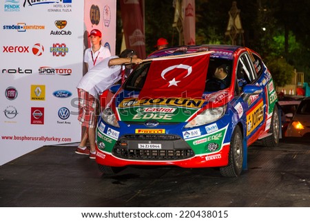 ISTANBUL, TURKEY - AUGUST 15, 2014: Umit Can with Ford Fiesta R2 car of Castrol Ford Team Turkiye in ceremonial start of Avis Bosphorus Rally
