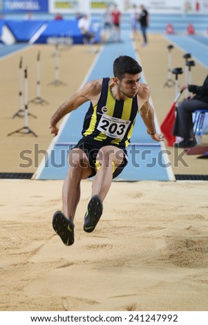 ISTANBUL, TURKEY - DECEMBER 27, 2014: Athlete Seyhmus Yigitalp triple jump during Athletics record attempt races in Asli Cakir Alptekin Athletics hall, Istanbul.