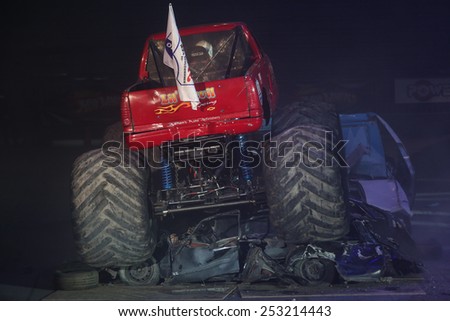 ISTANBUL, TURKEY - JANUARY 31, 2015: Monster Truck Lil Devil crush to old cars in Sinan Erdem Dome during Monster Hot Wheels stunt show.