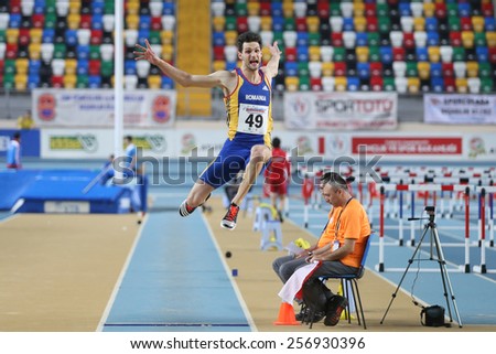 ISTANBUL, TURKEY - FEBRUARY 21, 2015: Rumanian athlete Grecu Ionut long jump during Balkan Athletics Indoor Championships in Asli Cakir Alptekin Athletics hall.