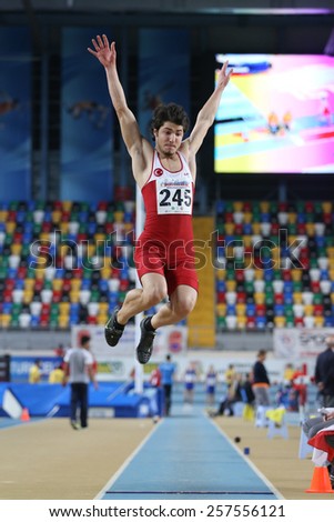 ISTANBUL, TURKEY - FEBRUARY 21, 2015: Turkish athlete Emre Dalkiran long jump during Balkan Athletics Indoor Championships in Asli Cakir Alptekin Athletics hall.