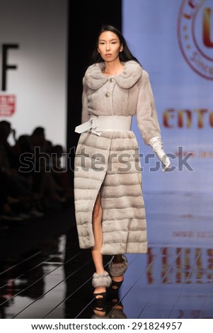 ISTANBUL, TURKEY - NOVEMBER 20, 2014: A model showcases one of the latest fashion creations in Istanbul Leather Fair
