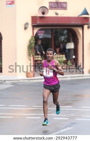 ISTANBUL, TURKEY - APRIL 26, 2015: Athlete is running in Old Town streets of Istanbul during Vodafone 10th Istanbul Half Marathon