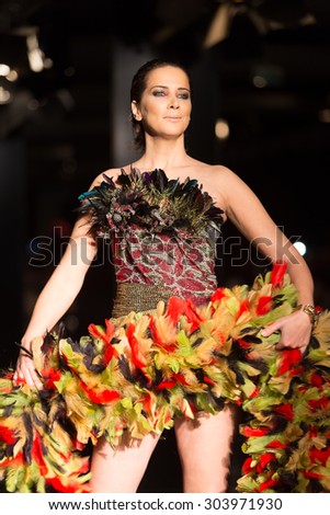 ISTANBUL, TURKEY - NOVEMBER 21, 2014: A model showcases one of the latest creations by Priamos in Fashionist fashion fair