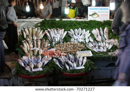 ISTANBUL, TURKEY - DECEMBER 04 : Fishmongers clean and sell fish at Karakoy fish market on December 04, 2010 in Istanbul. Karakoy fish market is the most popular fish market in Istanbul.
