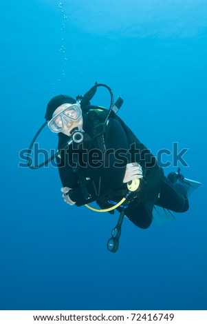 Adult female scuba diver in the blue. Tower, Sharm el Sheikh, Red Sea, Egypt.