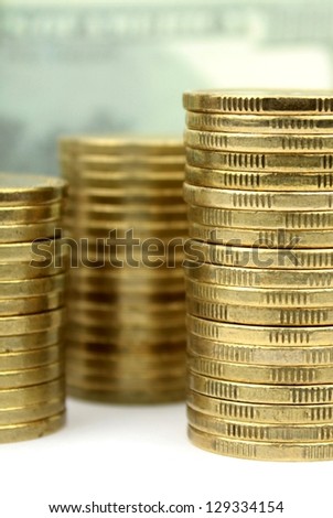 Stacked coins and dollar background.