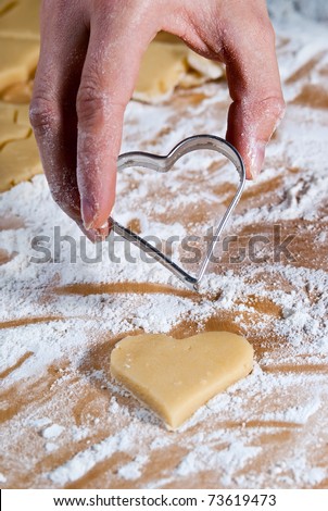 Heart shape is gouged in the dough by hand