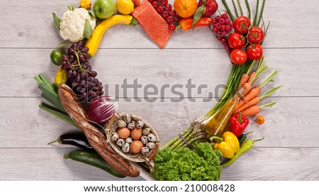 Heart shape by various vegetables and fruits / food photography of heart made from different fruits and vegetables on wooden table