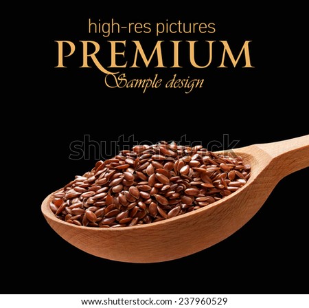 Linseed in a wooden spoon / cereal on wooden spoons isolated on black background with place for your text
