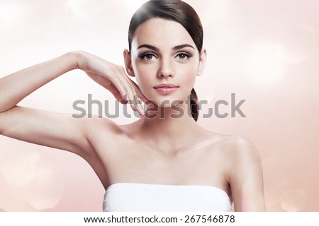 Beautiful woman touching her face, youth and skin care concept