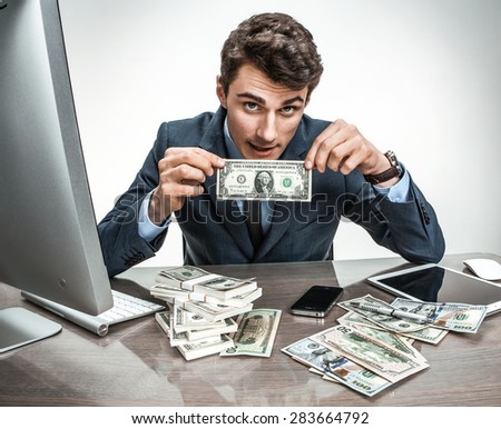 Clerk showing his earnings, profit, income, earnings, gain, benefit, margin / modern office man at working place, depression and crisis concept