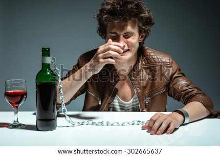 Alcoholic drunk man drinking wine, feeling depressed, falling into addiction problem / photo of youth addicted to alcohol, alcoholism concept, social problem