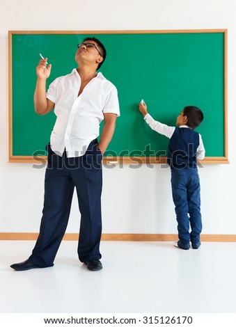 Bad teacher, poor education /  learning in the classroom / photo of teen school Chinese boy /  school theme
