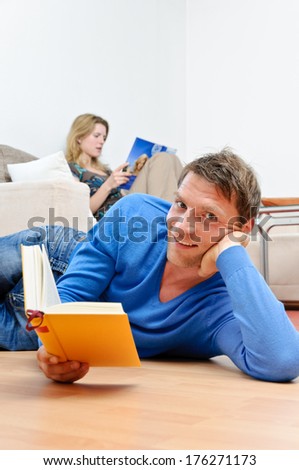 Couple reading together in the living room
