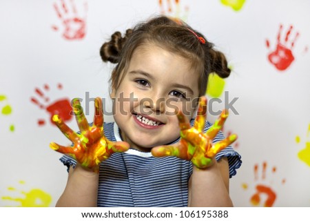 Happy child plays in the paint at home during the renovation
