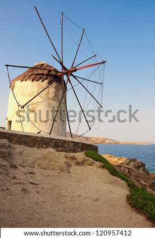 Very old windmill on a hill against the sea