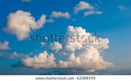 White fluffy cumulus clouds on a blue sky