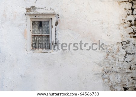 Old wall with a window with curtain shattered. Background. Texture
