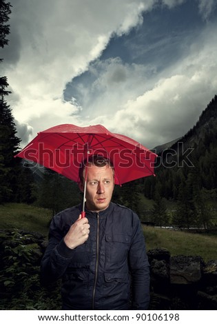 Man with broken umbrella being cranky