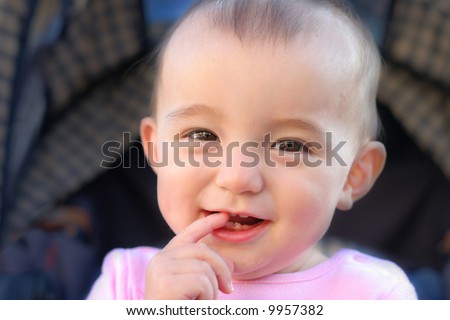 Cute Toddler smilling and biting finger