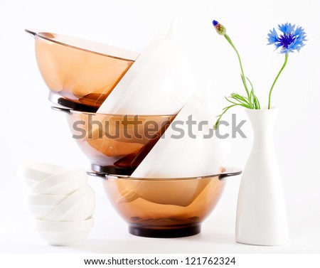 Pure white and brown dish, vase with blue flower on a light background