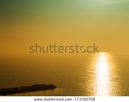 Fantastic beautiful sunset seascape with the horizon line disappears in the fog. Image shows a nice grain pattern at 100 percent