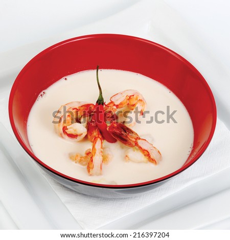 Milk soup with spicy shrimp in a red cup