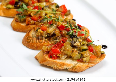 Bruschetta (Italian Toasted Garlic Bread) with stewed vegetables, selective focus. Creative cuisine.