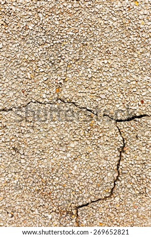 Concrete with small stones, cracks and scratches, weathered, worn. Grunge Concrete Surface. Great background or texture.