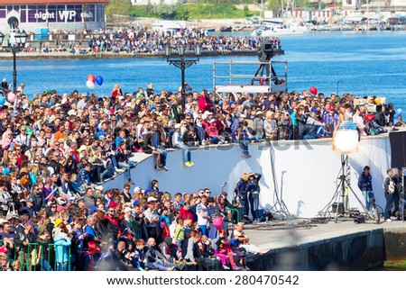 SEVASTOPOL, CRIMEA - MAY 9, 2015: A lot of people watching the parade in honor of the 70th anniversary of Victory Day on 9 May 2015, Sevastopol