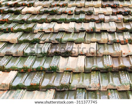 Tile roofed traditional wooden vintage home. Selective focus