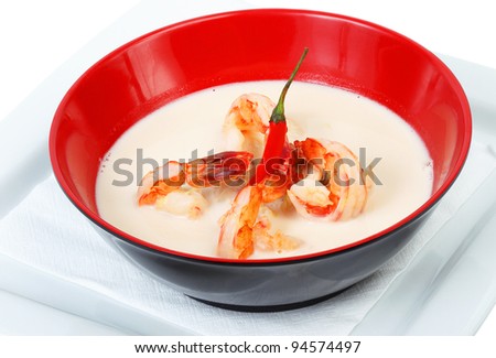 Milk soup with spicy shrimp in a red cup