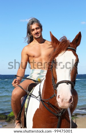 Middle-aged man on a horse on a summer day at the beach