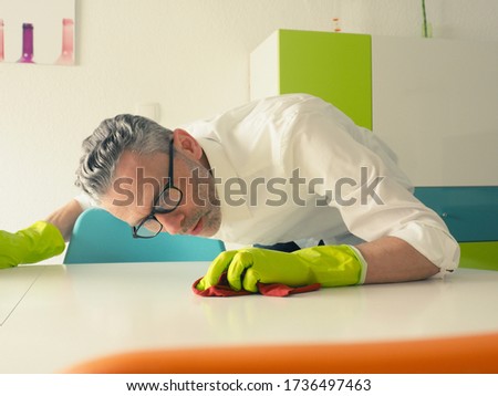 Image, Stock Photo Middle-aged man thoroughly cleans a tablet computer