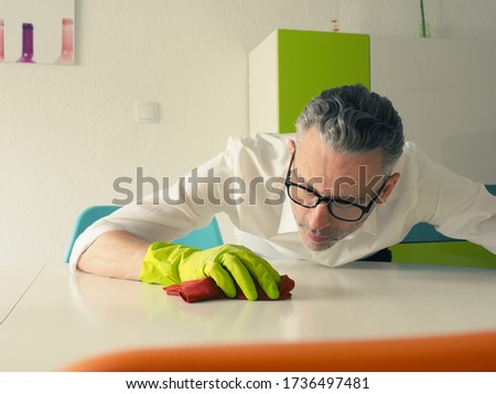 Similar – Image, Stock Photo Middle-aged man thoroughly cleans a tablet computer