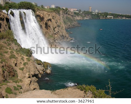 Rainbow over a waterfall in Antalia in Turkey in a hot bright sunny day