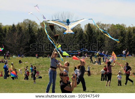 KORTRIGHT CENTER Ã¢Â?Â? MAY 06:  Woman with bird shaped kite at Four Winds Spring Kite Festival in May 06 2012 in Kortright Center in Ontario, Canada.