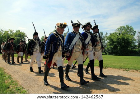 TORONTO - JUNE 15: The marsh of solgiers at reenactment of the conflict of Revolutionary War between refugees and Loyalists at  Black Creek -  in June 15 2013 in Black Creek Village, Toronto, Canada