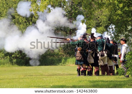 TORONTO - JUNE 15: Fire at reenactment of the conflict of Revolutionary War between refugees and Loyalists at  Black Creek -  in June 15 2013 in Black Creek Village, Toronto, Canada