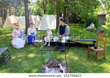 TORONTO - JUNE 15: The family in the camp at reenactment of the conflict of Revolutionary War between refugees and Loyalists at  Black Creek -  in June 15 2013 in Black Creek Village, Toronto, Canada