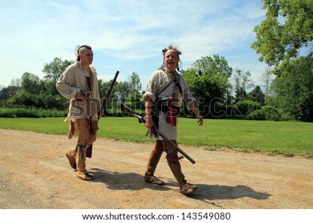 TORONTO - JUNE 15: Two Indian pathfinders at reenactment of the conflict of Revolutionary War between refugees and Loyalists at  Black Creek -  in June 15 2013 in Black Creek Village, Toronto, Canada