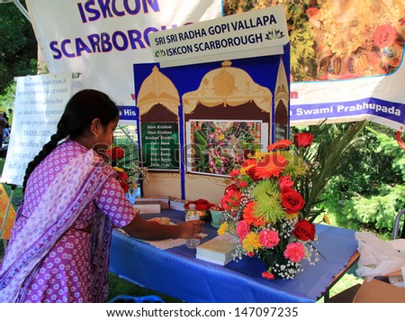 TORONTO - JULY 13: The girl decorating booth at 41-st Annual Festival of India in July 13, 2013 in Toronto, Canada