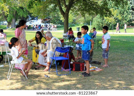 TORONTO – JULY 17:  Family at 39th Annual festival of India in July 17 2011 on Central Island in Toronto, Canada. The festival is a popular annual tourist attraction  for the last 39 years.
