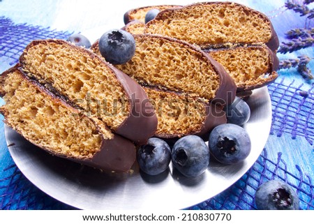 Blueberries and chocolate with lavender and spoon on wooden board