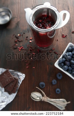 Beautiful morning with hot fruit cup of tea with some blueberries and chocolate