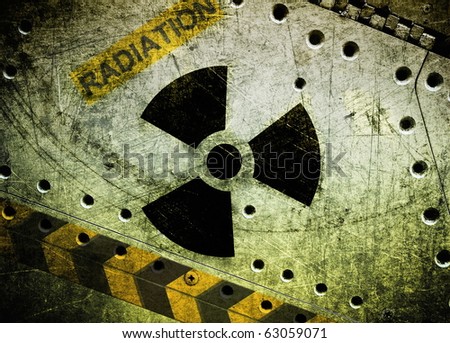 Radioactive symbol on metal plate, industrial grunge background